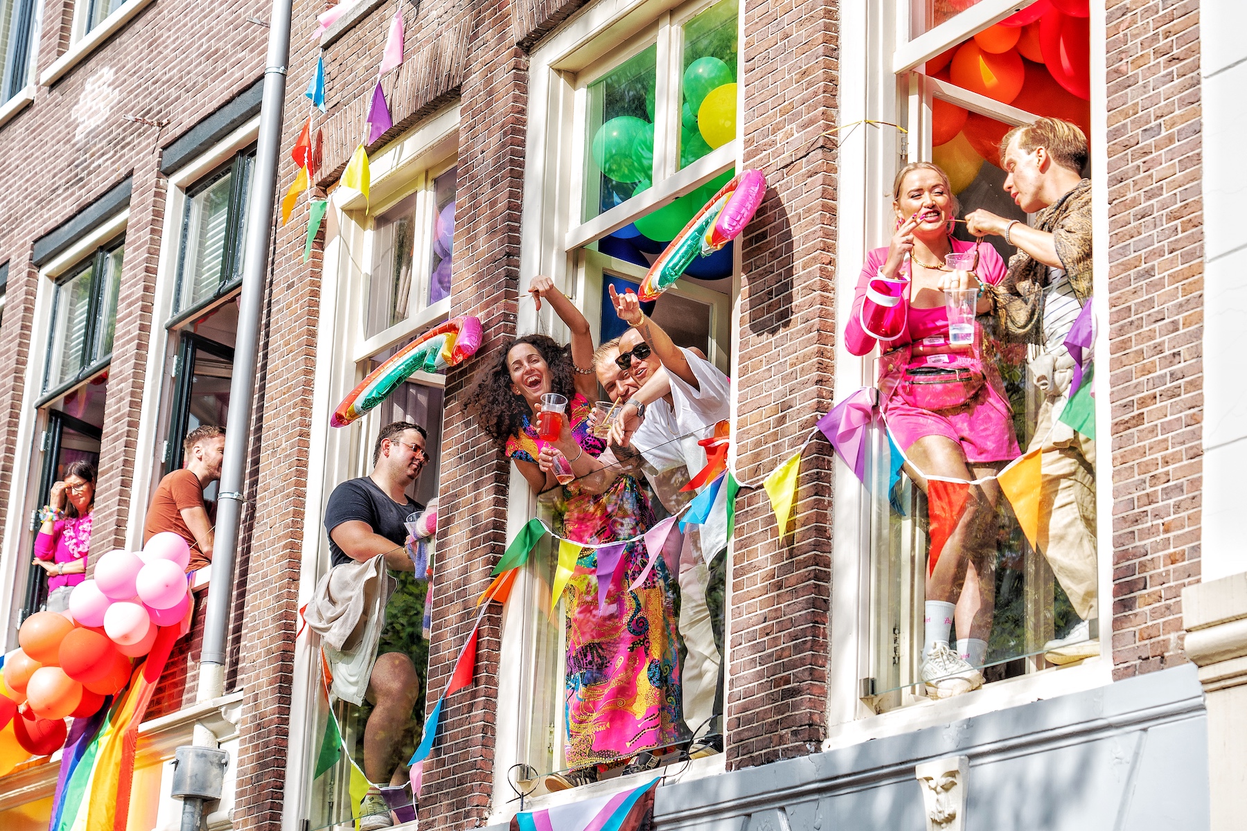 People stare out the window and wave in Amsterdam, Netherlands.
