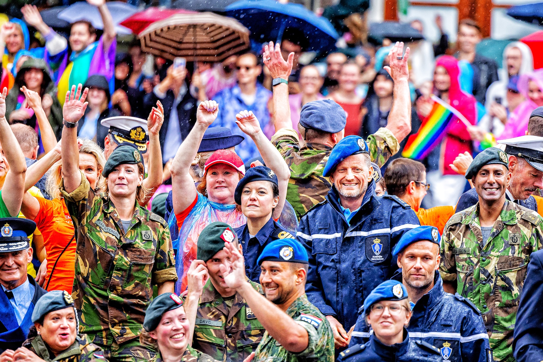 Dutch royals, wearing military-style uniforms, attend Pride march in Amsterdam.