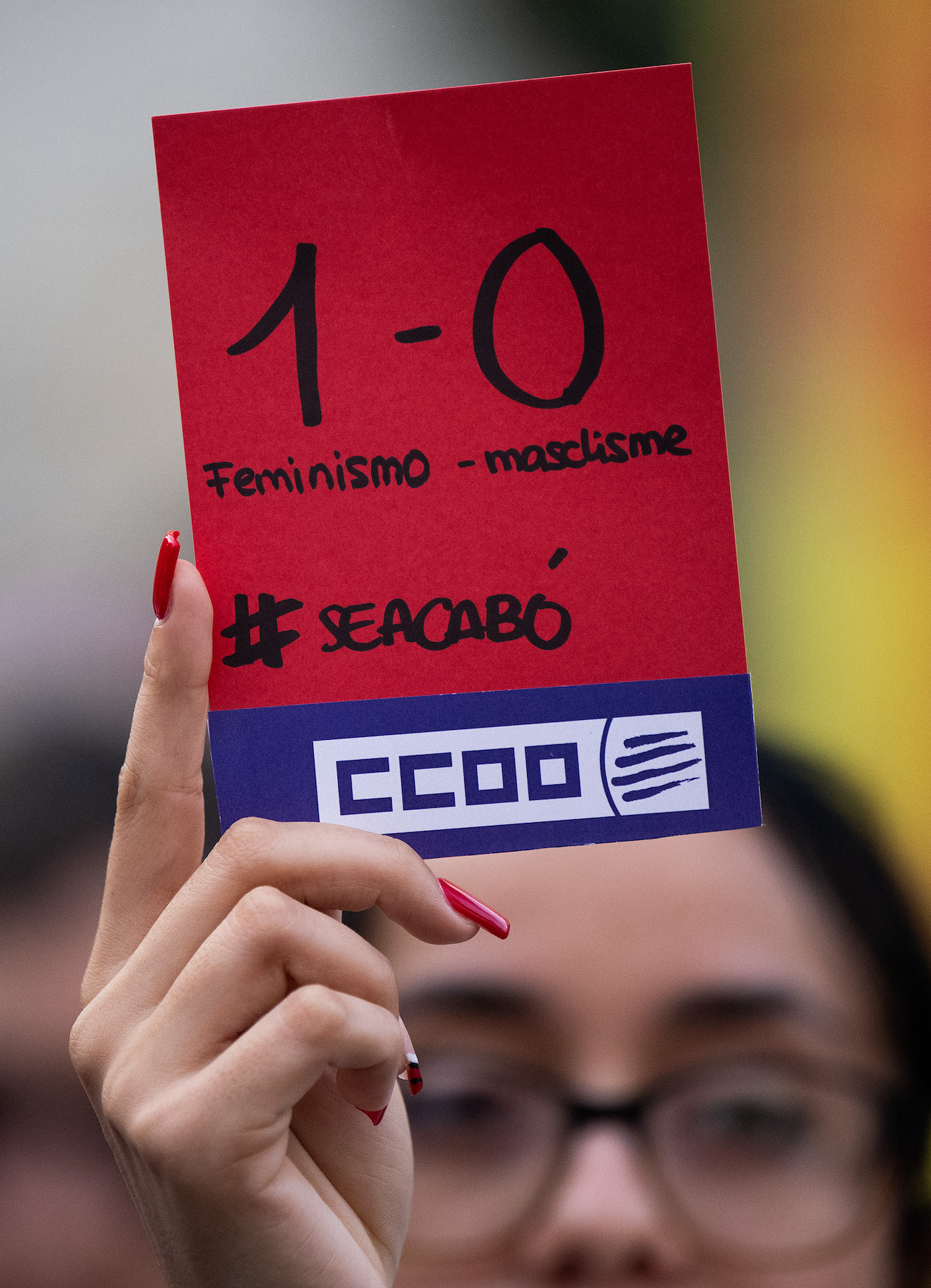 protester holds a red card spain football women world cup