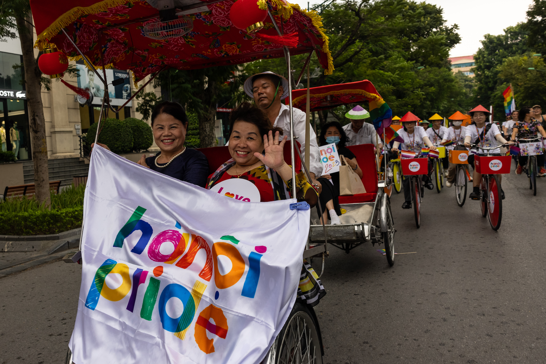 attendees waving in 2023 vietnam pride parade