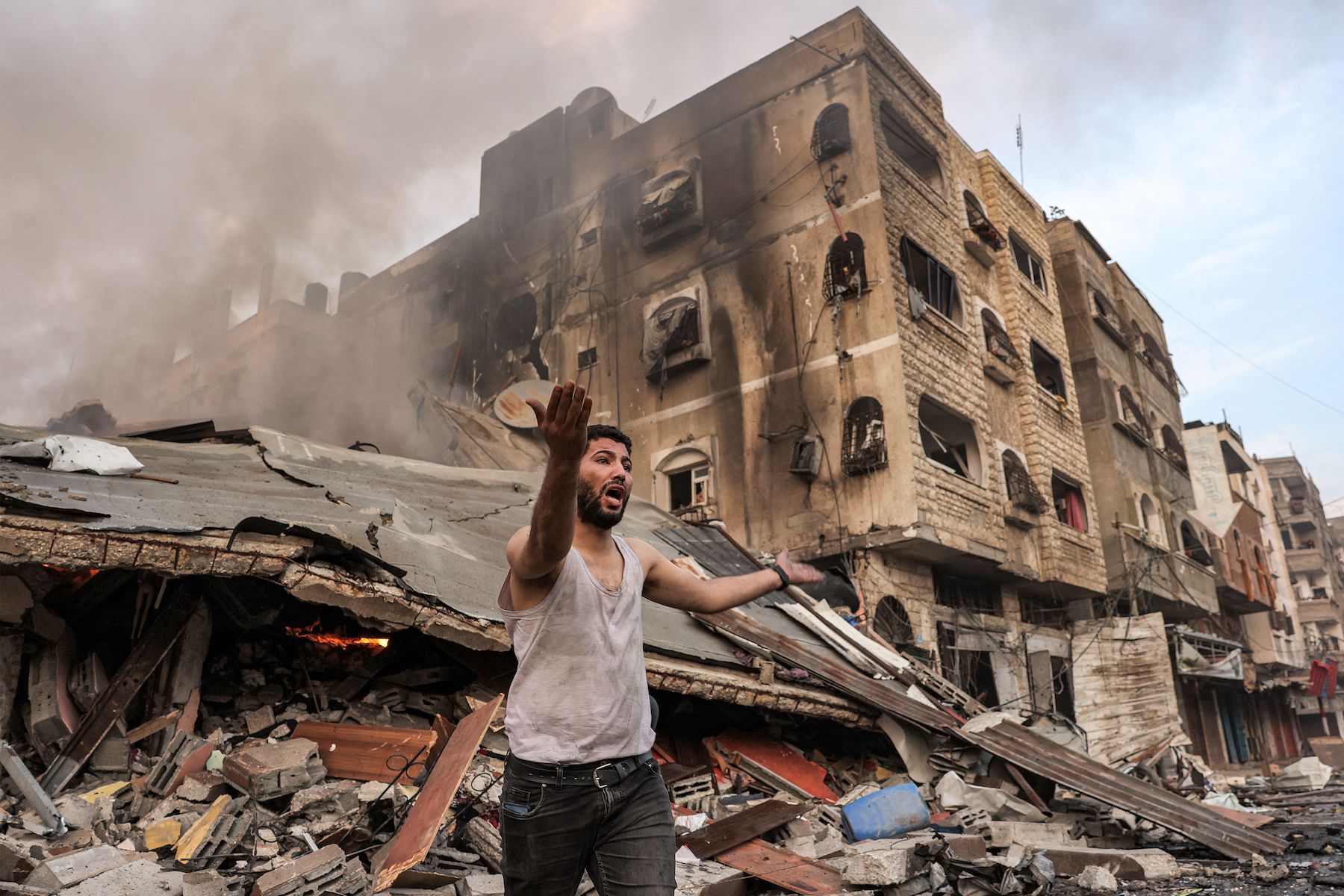 burning collapsed building-following-Israeli bombardment in Gaza City