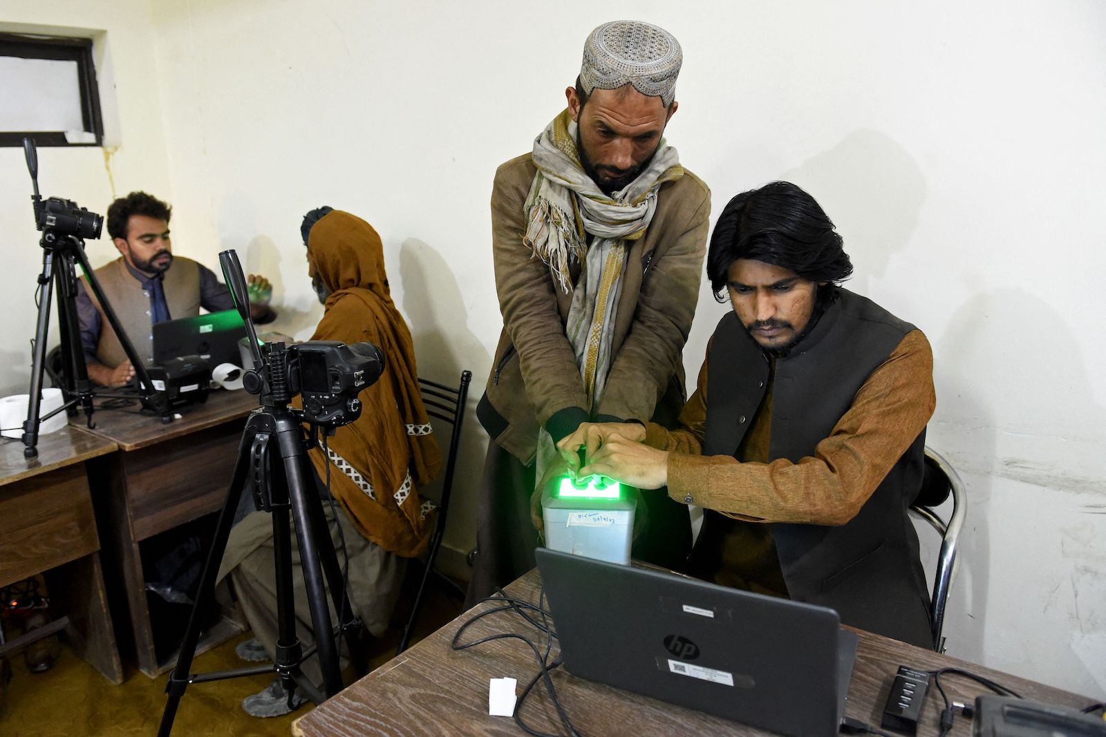 Afghan refugees provide biometric verification at a camp in Quetta