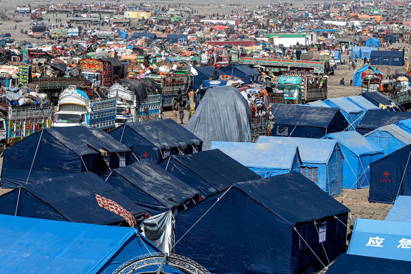 makeshift camps and trucks of Afghan refugees who arrived from Pakistan