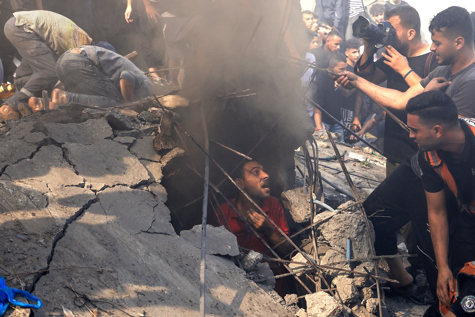 Palestinians check the rubble of a building