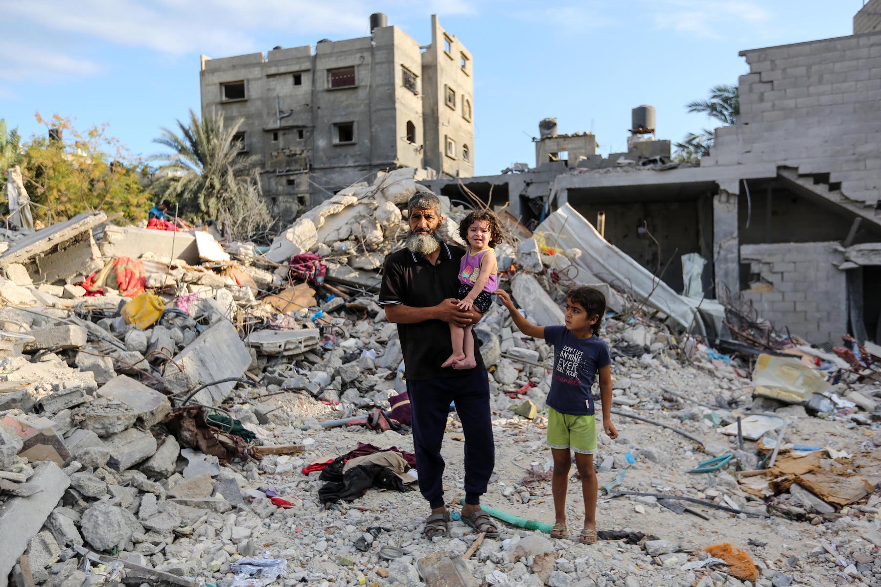 people search through buildings in gaza israel