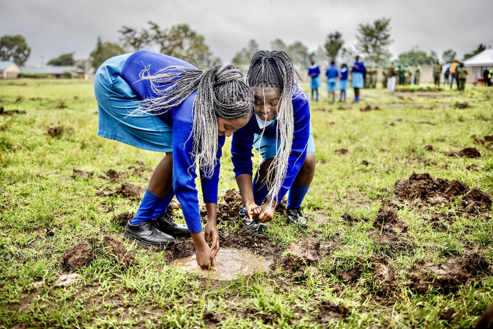 Students wash their hands on a puddle after planting tree seedlings nationwide tree planting public holiday in Nairobi kenya