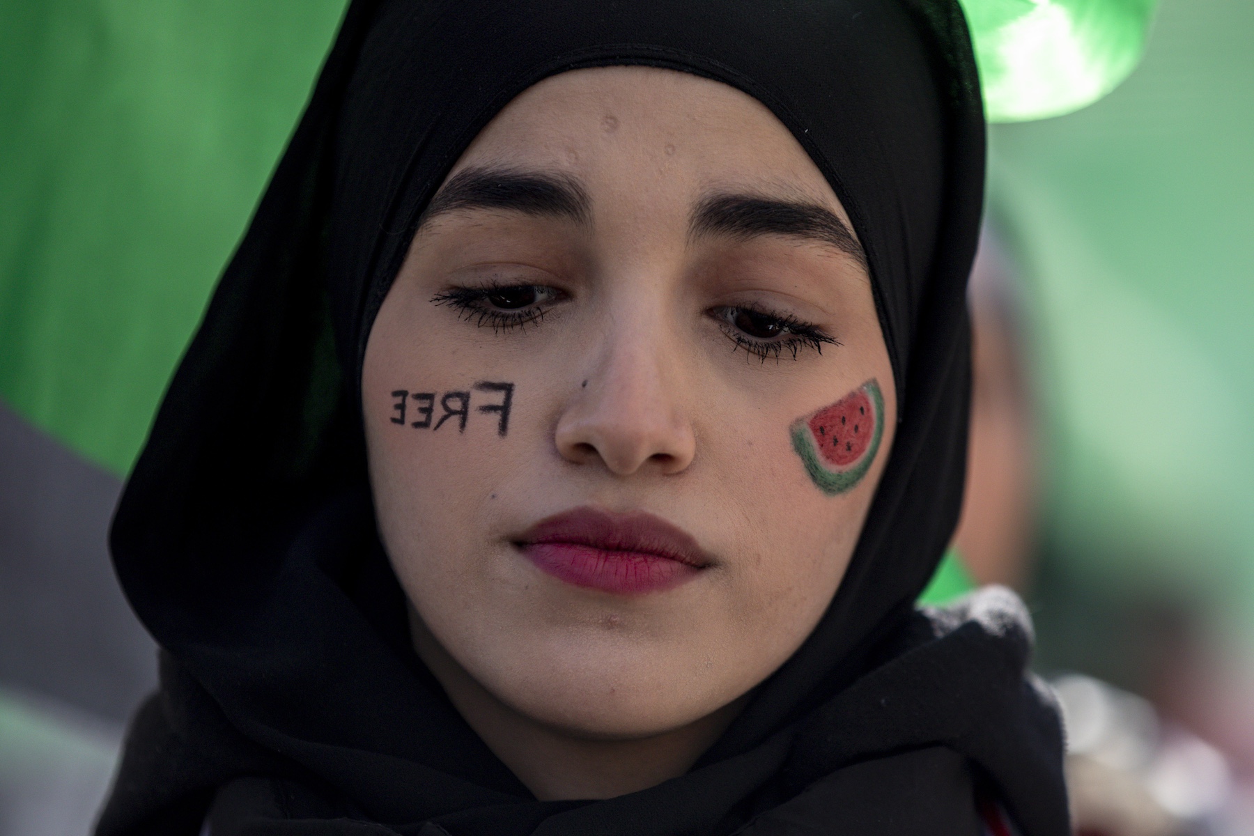 demonstrator wears face painting Free drawing of a watermelon