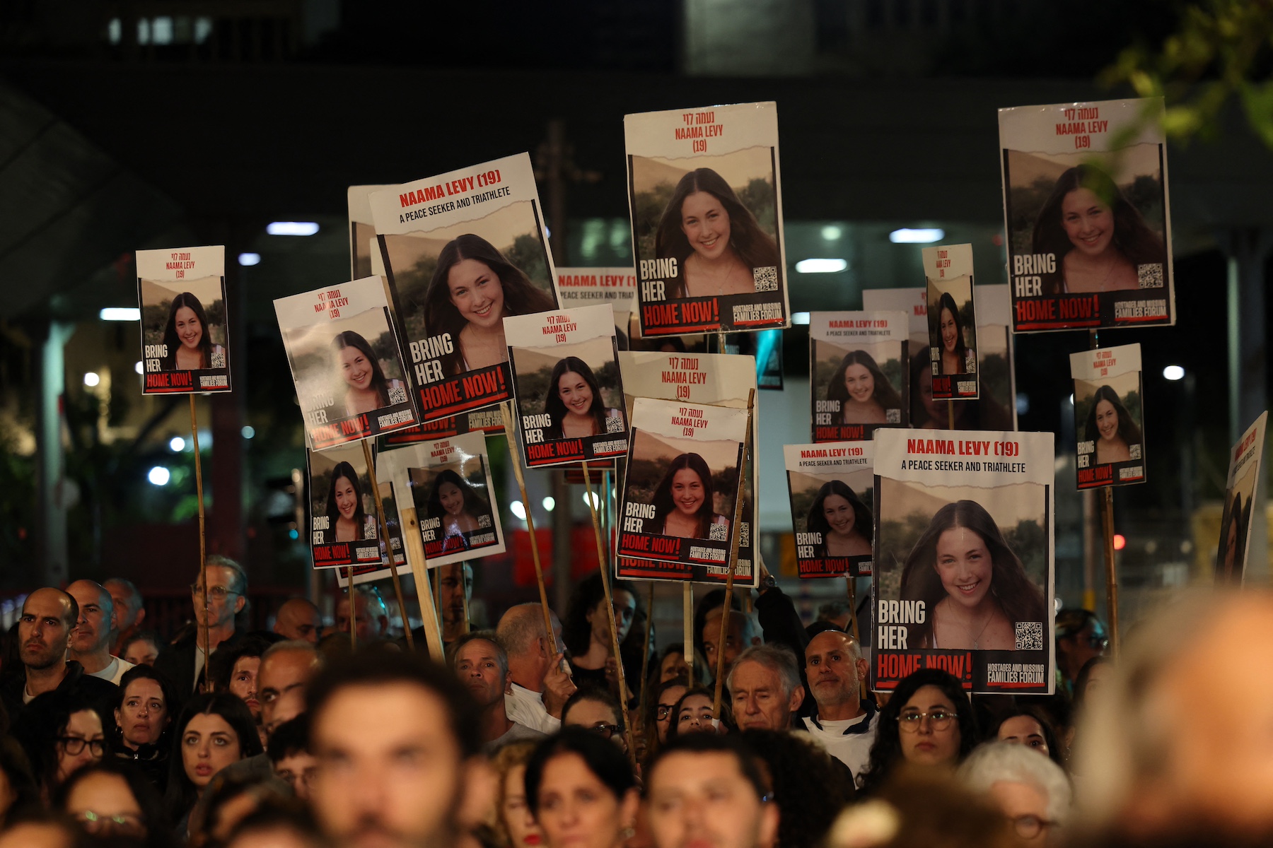supporters hold placards bearing portraits of Israeli hostages held in Gaza