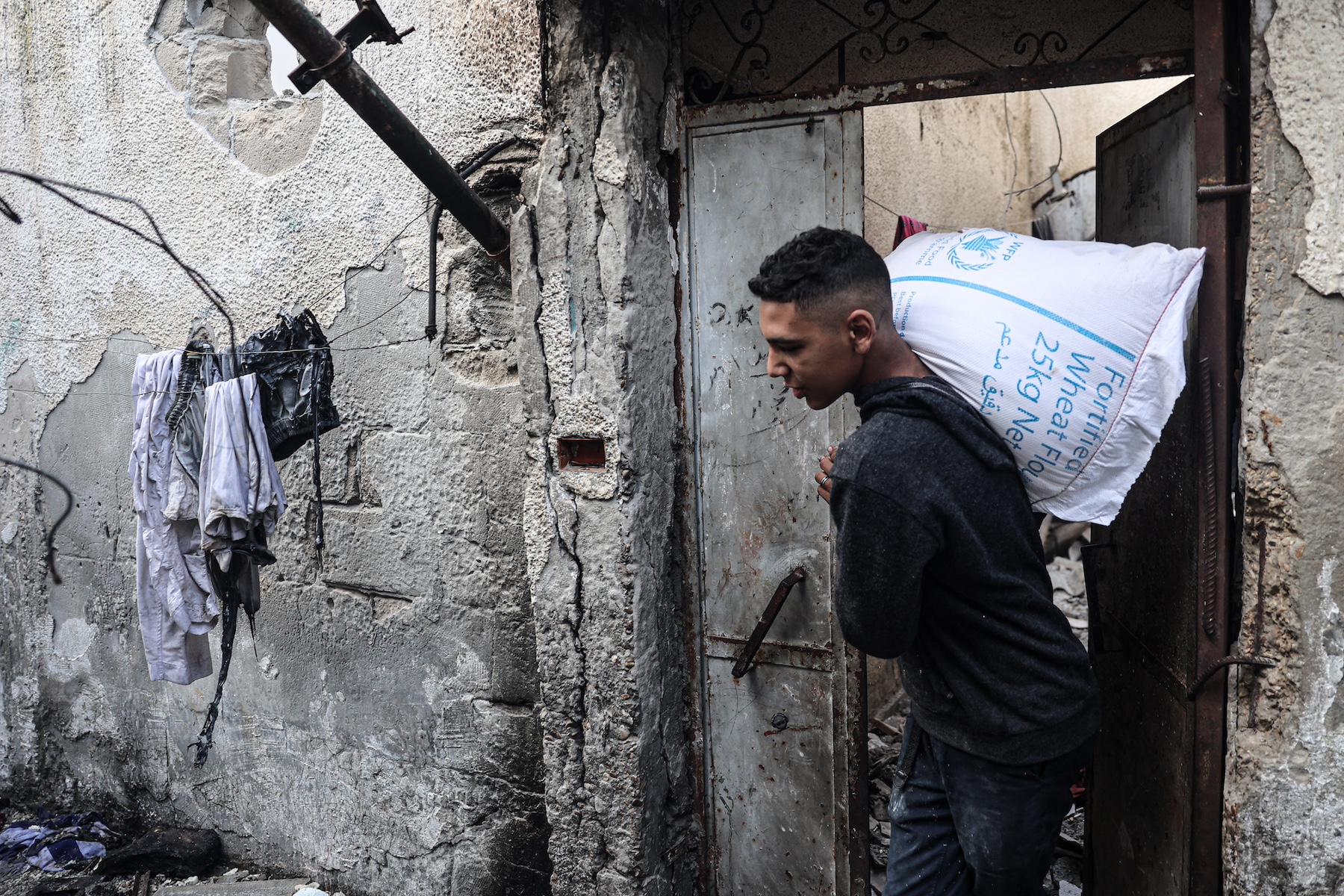 gaza israel war salvages bag flour damaged house