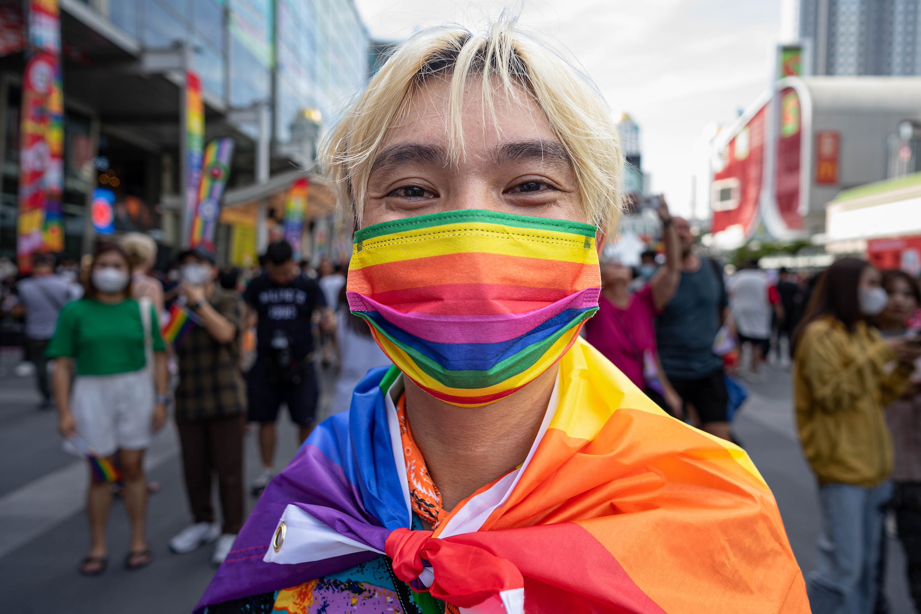 man wearing colorful mask pride parade thailand